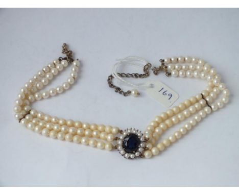 A pearl choker with a blue stone drop in silver gilt   