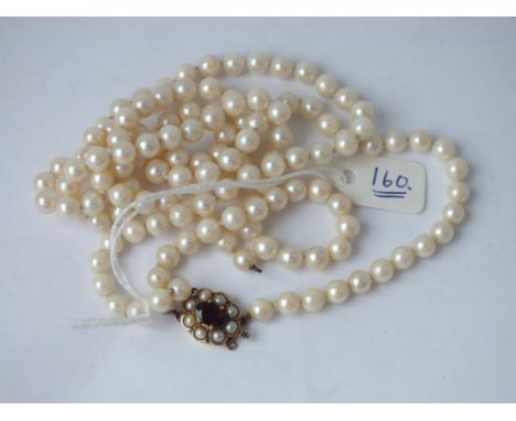 A double row of pearls wit garnet and pearl cluster clasp   