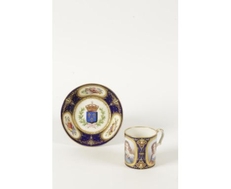 A "SEVRES" PORCELAIN CUP AND SAUCER painted with a portrait of Louis XIII between two portraits of ladies, within gold cartou