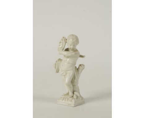 A BERLIN PORCELAIN FIGURE OF A PUTTI holding a mask and cornucopia standing beside a tree trunk, underglazed blue and impress