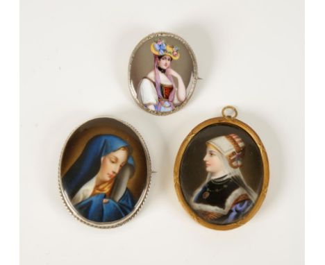 A CONTINENTAL PORCELAIN PAINTED MINIATURE mounted in a white metal brooch mount decorated with a portrait of Madonna, and two