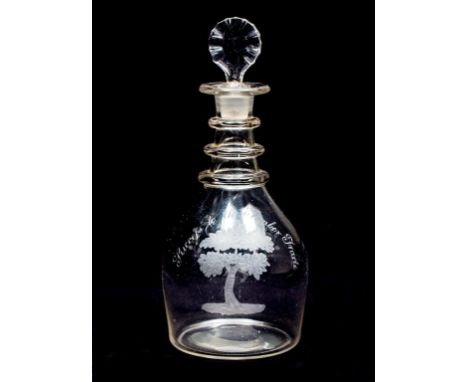 A GLASS DECANTER AND STOPPER, of club shape, inscribed "Succefs to Timber Trade" above an oak-tree, the reverse with "AM" ini