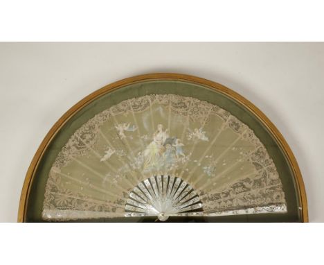 A PAINTED LACEWORK FAN, the broad leaf painted with a central scene of a lady writing at her journal surrounded by winged che