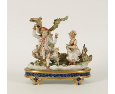 A CONTINENTAL PORCELAIN FIGURE GROUP of a girl and boy sitting on a tree trunk playing with a dog, on an oval plinth base wit