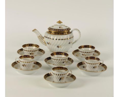 A WORCESTER PORCELAIN PART TEA SET with gilt decoration on blue and white ground. Comprising teapot, four tea bowls, three co