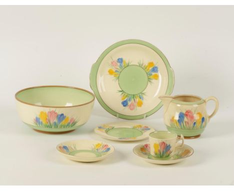 A CLARICE CLIFF PART TEA SERVICE with crocus decoration on a cream and green ground. Comprising salad bowl, cake plate, jug, 