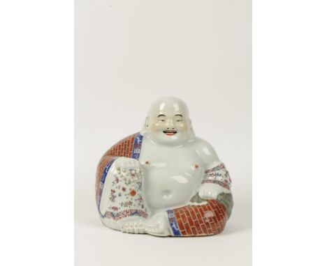 A CHINESE PORCELAIN FIGURE OF BUDDHAI, the corpulent sage holding rosary beads and a sack, picked out in famille rose enamel 