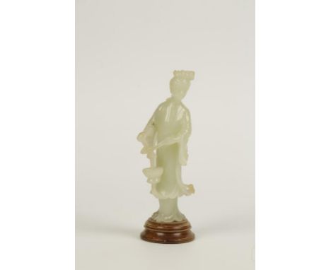 A CHINESE CARVED CELADON JADE FIGURE OF A MAIDEN, standing holding a basket, 20th century, 15cm high (excluding wood stand)