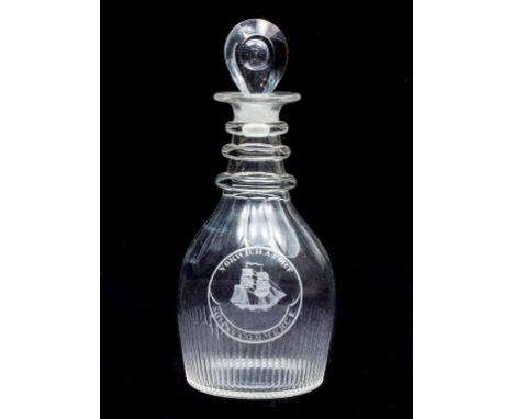 A GLASS DECANTER AND STOPPER, the upper and lower parts cut with narrow and wide flutes, conforming to an engraved circular l
