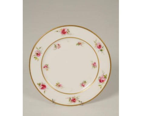 A ROYAL WORCESTER PORCELAIN PLATE with painted rose decoration on white ground within gilt borders, puce mark, late 19th/earl