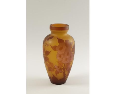 MANNER OF GALLE: AN ART NOUVEAU STYLE CAMEO GLASS VASE with decorative flowers in pink and red against a yellow ground, with 