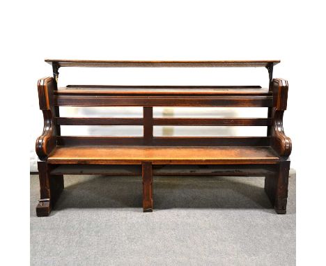 Victorian oak choir stall/ pew, with rear shelf and additional music shelf (removable), the scrolled ends carved with Gothic 