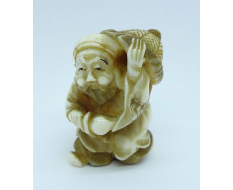 A carved ivory netsuke 