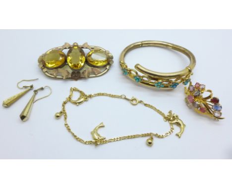 A Victorian brooch set with citrines, a/f, a double hinged plated bangle set with turquoise, a gem set brooch, a dolphin brac