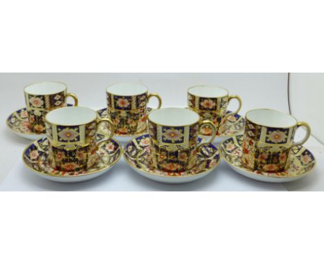 A set of six Royal Crown Derby 2451 coffee cans and saucers 