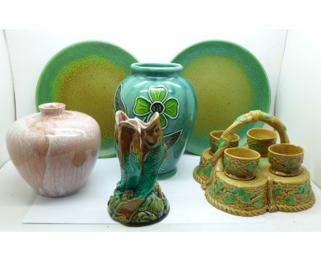 A Majolica triple fish vase, a/f, Majolica egg cups and stand, two Royal Doulton plates with green and brown ground, 3266 bac