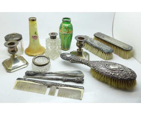 A pair of dwarf silver candlesticks, silver backed brushes, comb, silver handled button hook and shoe horn and other silver r