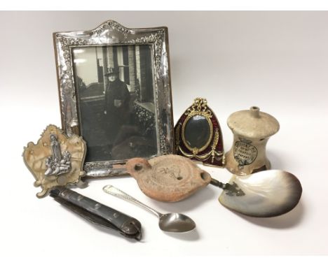 A hallmarked silver embellished photo frame, hallmarked Chester, a silver spoon, a pen knife, a large mother of pearl spoon, 