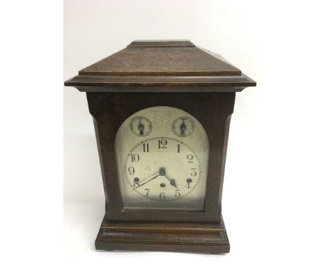A German Schwenningen Kienzle oak mantle clock with engraved brass face.Approx 35cm high