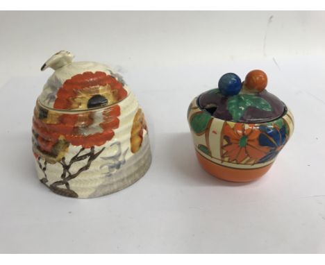 Two Clarice cliff preserve pots decorated with umbrellas and rain hairline crack and  rhodanthemum , slight paint loss to bot