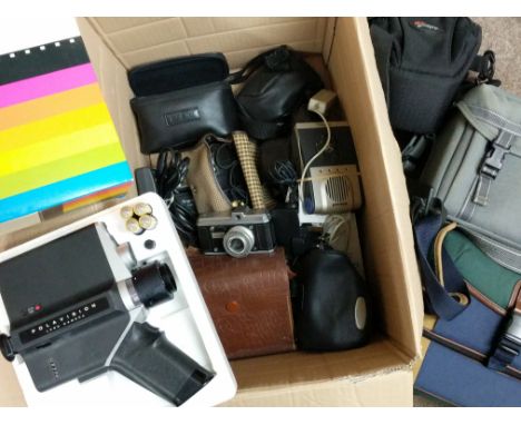 A box of cameras and accessories plus a boxed Polaroid Polavision land camera and screen.