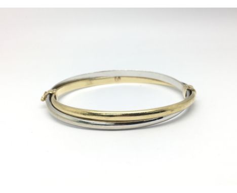 A 9ct gold two tone bangle, total weight approx 7.5 grams.