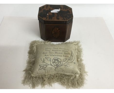 A small mahogany and boxwood inlaid tea caddy with tortoiseshell top and a late Victorian pin cushion stitched with inscripti