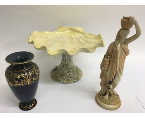 A Worcester blush ivory female water carrier, a gilded Doulton vase and a Bretby shell shaped comport