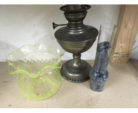 A oil lamp with green glass shade