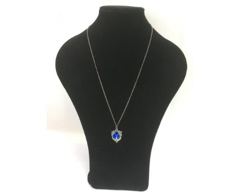 A silver and enamel pendant.