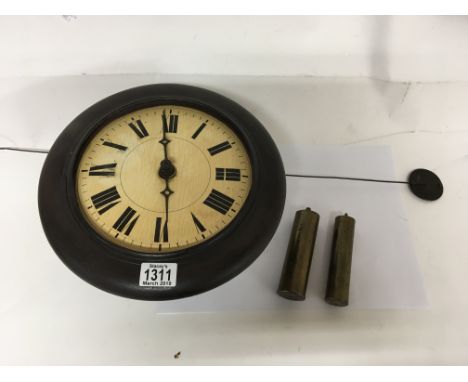 A Victorian postman’s alarm clock with a painted wood vase pendulum and two weights.