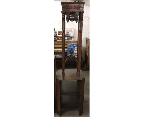 A reproduction carved wood plant stand and an Art Deco open shelf occasional table