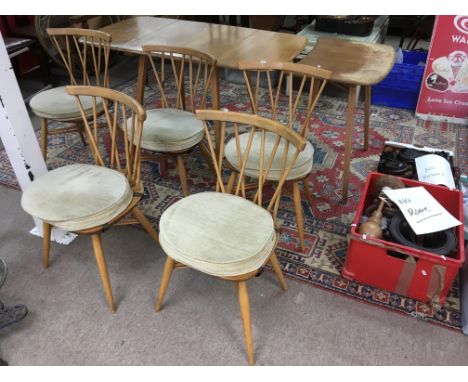 An Ercol light elm dining table and extension plus five marching Windsor double stickback chairs. Table approx 73x136cm fully