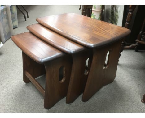 An Ercol nest of three Windsor tables.