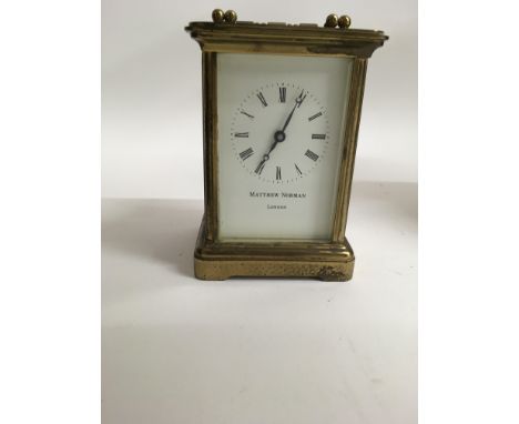 A brass case carriage clock Matthew Norman the dial with Roman numerals