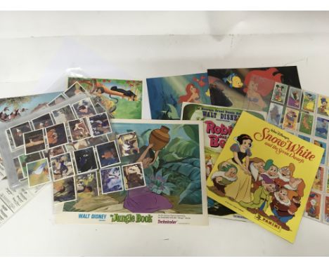 A collection of Vintage Walt Disney lobby cards and Pannini collectors cards.