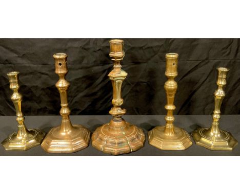 A George I brass candlestick, canted square base, c.1725; another, French, c.1760; others (5) 