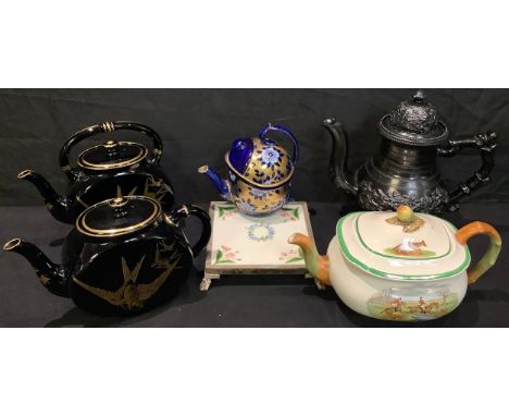 A Victorian Aesthetic black glazed teapot, gilt decorated with swifts; another similar; an early 19th century Jackfield type 