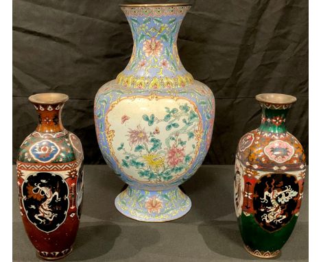 A Chinese cloisonne vase, 25cm high; another, 25cm high and a Cantonese enamel vase, painted in polychrome, 38cm high (3) 