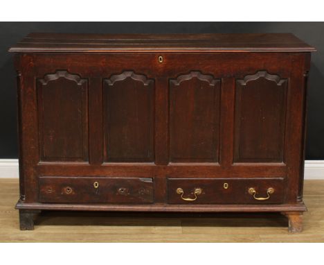 A George III oak mule chest, hinged cover enclosing three small drawers, the front with four raised and fielded panels above 