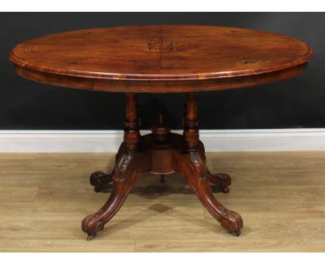 A Victorian walnut and marquetry centre table, quarter-veneered oval tilting top, quad-columnar supports centred by a spire f