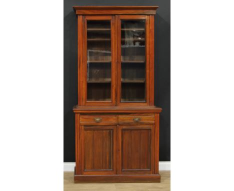 A late Victorian/Edwardian library bookcase, moulded cornice above a pair of glazed doors enclosing four shelves, the project