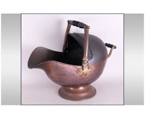 Early Victorian Copper Helmet Shaped Coal Scuttle on a plinth. With a loop handle with wooden grip.