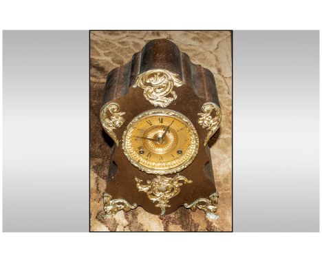 American Ansonia Clock Co Metal Mantle Clock made in the French style, the shaped case in wood finish, with gilt integral mou