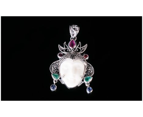 Hand Made Balinese Gem Set 'Serene Goddess' Pendant, the elaborate silver headdress set with a pear cut ruby, two pear cut em