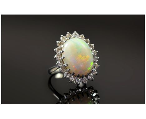 18ct White Gold Opal and Diamond Cluster Ring. The Large Opal Surrounded by 20 Small Diamonds, Diamond Weight Approx 1.5cts. 