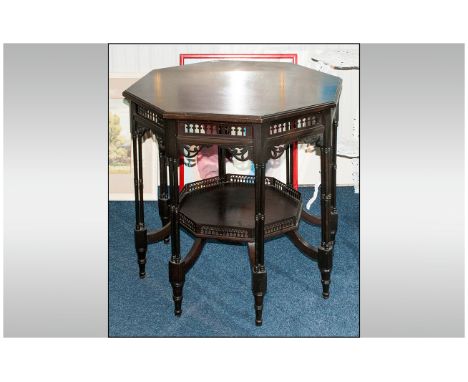 Edwardian Aesthetic Ebonised Octagonal Topped Centre Table of unusual figuration, with 8 double column legs. With fretted fri