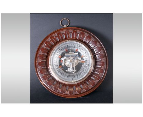Wall Barometer, with carved edge, of circular shape. The face open to reveal The Barometer works. 10'' in diameter.