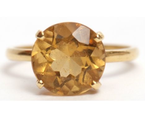 Lemon citrine dress ring, circular faceted cut, four claw set and raised in a basket setting to a plain polished mount, stamp