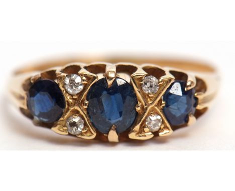 Early 20th century 18ct gold blue stone and diamond ring, the three graduated stones interspersed by 4 small single cut diamo